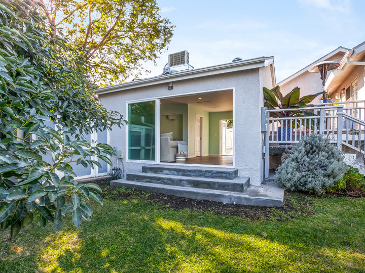 Inspiration for a large coastal detached three-car garage workshop remodel