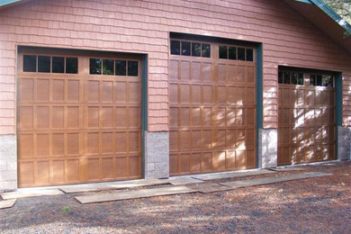 Garage - large attached three-car garage idea in Columbus