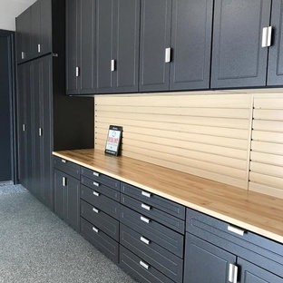 Example of a mid-sized trendy attached two-car garage workshop design in Oklahoma City