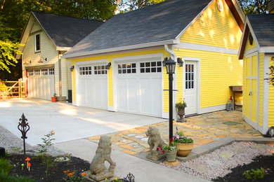 Example of a large arts and crafts detached three-car garage design in Cincinnati