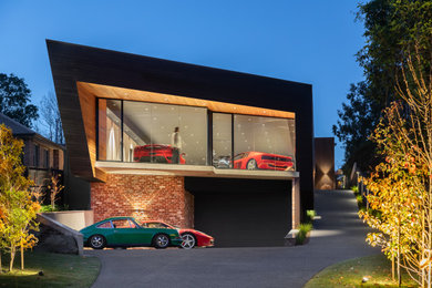 Cette photo montre un grand garage pour quatre voitures ou plus séparé moderne avec un bureau, studio ou atelier.