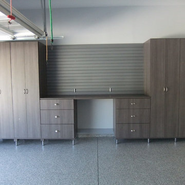 Garage w/large cabinets, work bench area with drawers, slat wall, adjusted/level