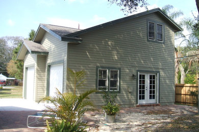 Example of a large arts and crafts detached two-car garage design in Orlando