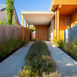 Design ideas for a small contemporary attached one-car carport in Melbourne.