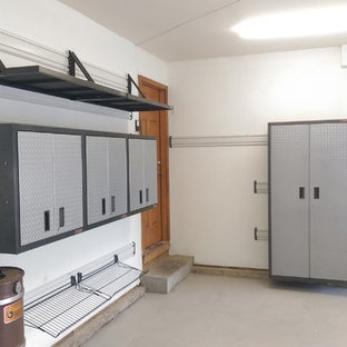 Inspiration for a mid-sized transitional attached two-car garage workshop remodel in Denver