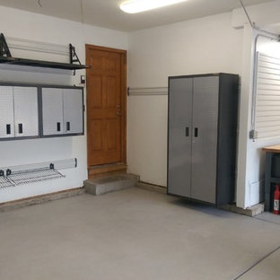 Inspiration for a mid-sized transitional attached two-car garage workshop remodel in Denver