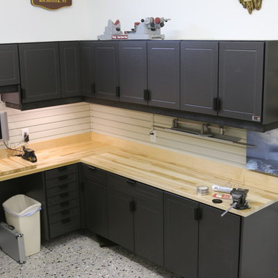 Mid-sized transitional attached one-car garage workshop photo in Other