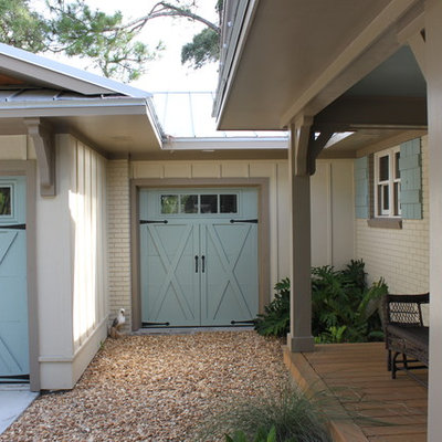 Garage - mid-sized tropical attached one-car garage idea in Jacksonville