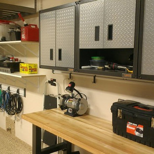 Inspiration for a mid-sized transitional attached two-car garage workshop remodel in Denver