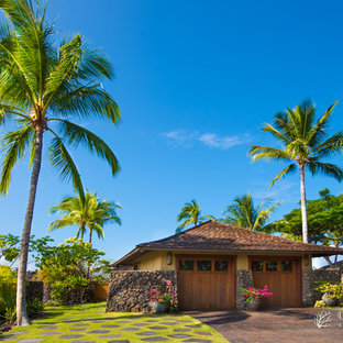 Example of a large island style detached two-car garage design in Hawaii