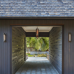 Example of a mountain style one-car carport design in Minneapolis