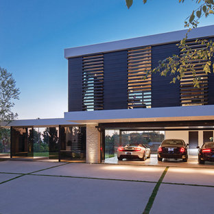 Garage - large contemporary attached three-car garage idea in Los Angeles