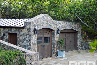 Large mountain style detached two-car carport photo in Orange County
