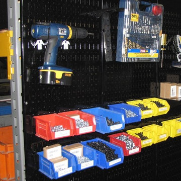 Metal pegboard tool boards being used to create storage space on the end of pall