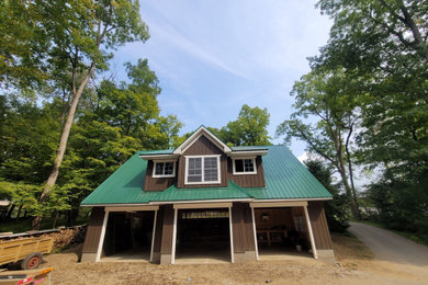 Example of a large detached three-car garage design in Cleveland