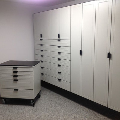 Example of a large transitional attached two-car garage workshop design in Other