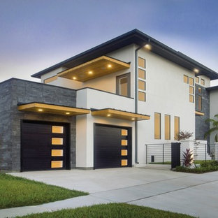 Idées déco pour un grand garage pour deux voitures attenant moderne.