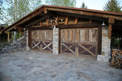 Garage - small rustic attached two-car garage idea in Other