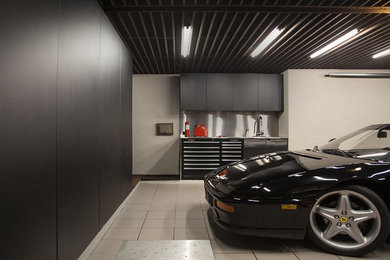 Garage - contemporary one-car garage idea in Montreal