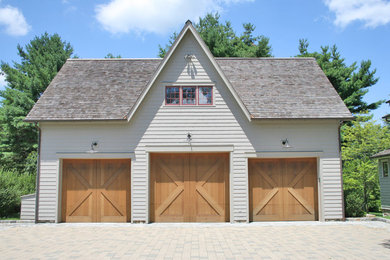 Example of a large cottage detached three-car garage design in New York