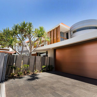 Garage - tropical two-car garage idea in Brisbane
