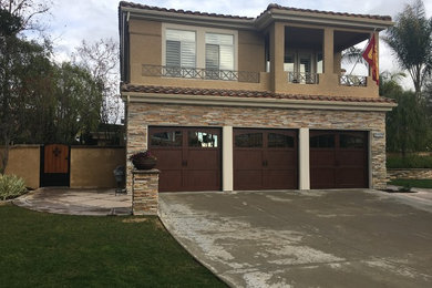 This is an example of a medium sized classic attached garage in Orange County with three or more cars.