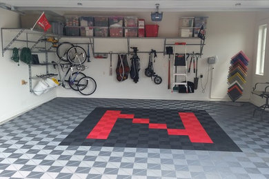 Mid-sized trendy attached two-car garage workshop photo in Omaha