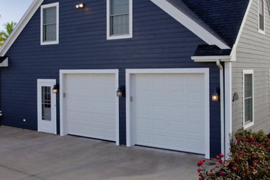 Mid-sized elegant attached two-car garage photo in Other