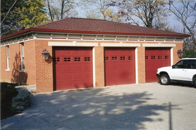 Garage - large traditional attached three-car garage idea in Other