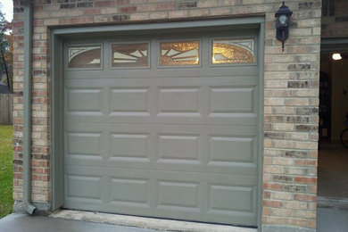 Example of a mid-sized transitional attached one-car garage design in Houston