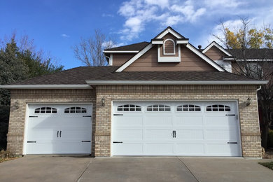 This is an example of a medium sized contemporary attached garage in Denver with three or more cars.