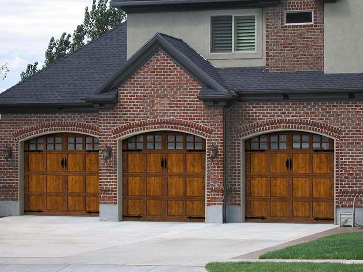 Inspiration for a large craftsman attached three-car garage remodel