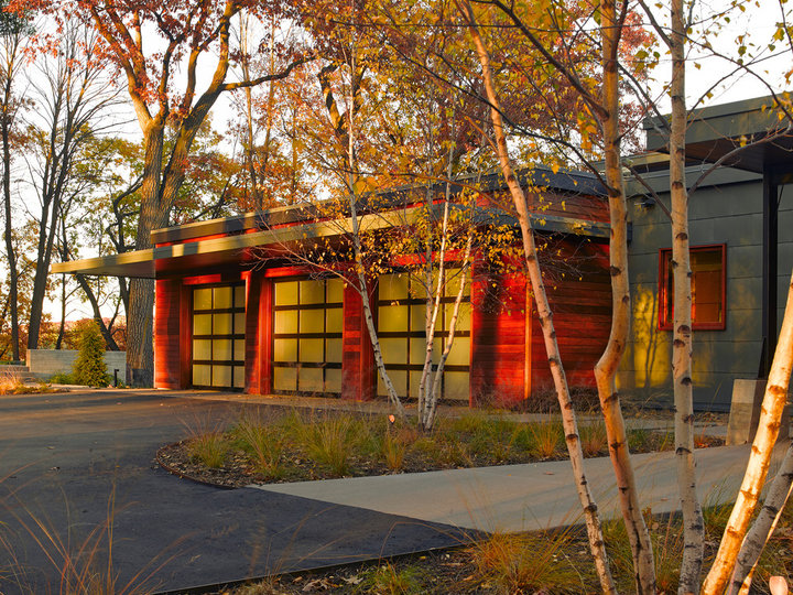 Inspiration for a huge modern attached three-car garage remodel