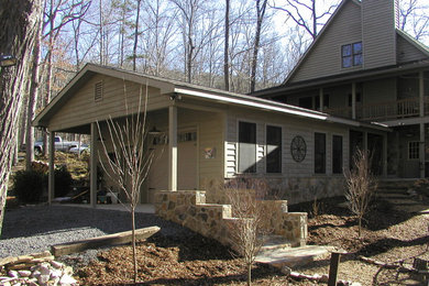Example of a farmhouse attached one-car garage design in Other
