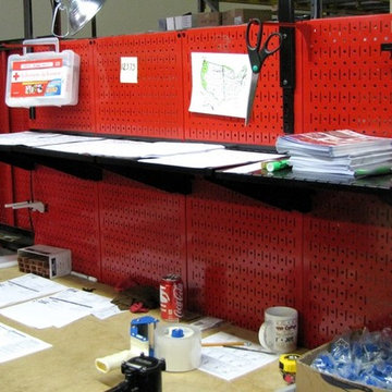 Red industrial tool board being used to create a packaging station | Industrial