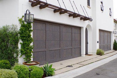 Large mountain style attached four-car garage photo in Orange County