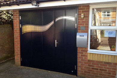 This is an example of a small contemporary attached single garage in Other.