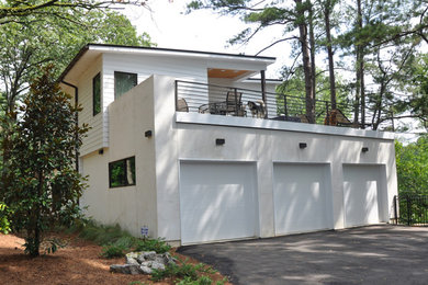 Inspiration for a large contemporary attached three-car garage remodel in Jackson
