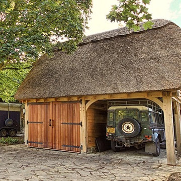 Thatched oak framed garage building with open carport and guest accommodation ab