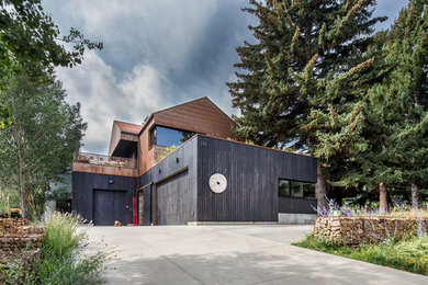 Example of an urban attached garage design in Salt Lake City