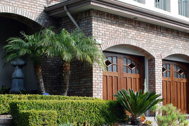 Example of a large classic attached three-car garage design in Orange County