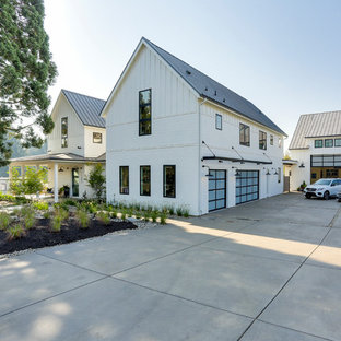 Inspiration for a large cottage attached three-car garage remodel in Portland