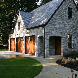 Garage - mid-sized traditional detached three-car garage idea in Other