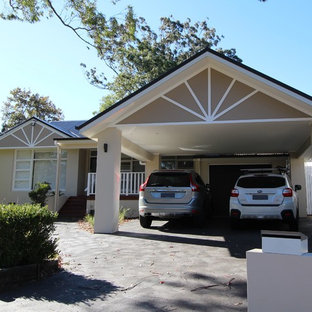 Photo of a mid-sized traditional attached three-car carport in Sydney.