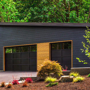 Example of a trendy attached three-car garage design in Seattle