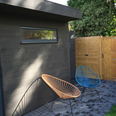 Inspiration for a mid-sized contemporary detached studio / workshop shed remodel in Surrey