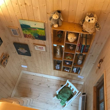 Interior of 'The Crooked House' treehouse from mezzanine.