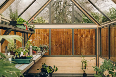 This is an example of a medium sized modern detached greenhouse in Other.