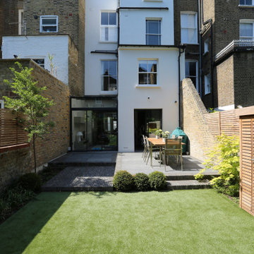 Small garden in Maida Vale with clay pavers, blue stone and iroko trellis