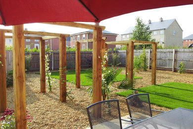 Medium sized back formal garden in Other with gravel.